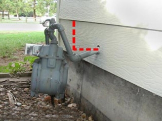 Bent Natural Gas Meter on Exterior of House