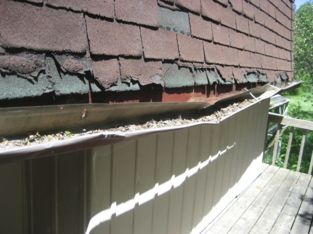 Mansard Roof has Damaged Shingles & Gutter found by Barrie Home Inspections