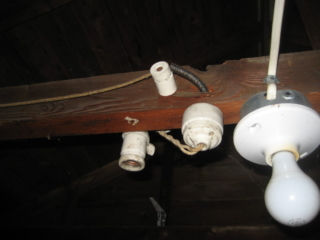 Old Knob and Tube left in place in attic.  Should have been removed when romex installed.